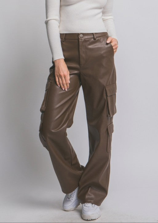 Person wearing brown cargo pants and a white long-sleeve shirt on a plain background